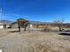 Expansive backyard with desert landscape, shed, and partial fencing offering ample space at 1681 Appaloosa Ln, Pahrump, NV 89060