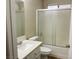 Bathroom with a shower and bathtub combination with a framed sliding glass door, toilet, and sink at 1681 Appaloosa Ln, Pahrump, NV 89060