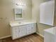 Bathroom features a white vanity with drawers and cabinet, a large mirror, and a window at 1681 Appaloosa Ln, Pahrump, NV 89060