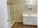 Bathroom features a glass shower, a white vanity with drawers and cabinet, and a large mirror at 1681 Appaloosa Ln, Pahrump, NV 89060