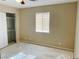 Bedroom with open closet, window with blinds, baseboard and fan and light at 1681 Appaloosa Ln, Pahrump, NV 89060