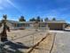 Spacious home with large garage, fenced yard, and desert landscaping offering privacy and functionality at 1681 Appaloosa Ln, Pahrump, NV 89060