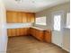 Bright kitchen featuring wood cabinets, wood-look flooring, and ample counter space at 1681 Appaloosa Ln, Pahrump, NV 89060
