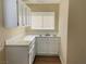 Laundry Room features a white cabinets and countertops a sink, and a window with blinds at 1681 Appaloosa Ln, Pahrump, NV 89060