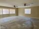 Living Room with multiple windows with blinds, baseboard and two fans with lights at 1681 Appaloosa Ln, Pahrump, NV 89060