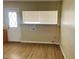 Functional utility room area featuring wood-look flooring and a window for natural light at 1681 Appaloosa Ln, Pahrump, NV 89060