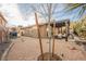Spacious backyard showcasing a pergola-covered patio, landscaped gravel, and lush greenery creating a serene oasis at 204 Mchenry St, Las Vegas, NV 89144