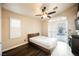 Bedroom with wood-look floors, ceiling fan, shutters and sliding doors to backyard at 204 Mchenry St, Las Vegas, NV 89144
