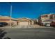 Inviting single story home features a two car garage and low maintenance desert landscaping at 204 Mchenry St, Las Vegas, NV 89144