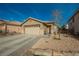 Inviting single story home features a two car garage and low maintenance desert landscaping at 204 Mchenry St, Las Vegas, NV 89144