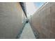 Narrow walkway along house leads to backyard area at 204 Mchenry St, Las Vegas, NV 89144