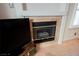 Close-up of the fireplace surrounded by tile, next to a television in the living room at 204 Mchenry St, Las Vegas, NV 89144
