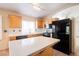 Well-lit kitchen with an island, stainless steel appliances, and wooden cabinetry for a functional and stylish cooking space at 204 Mchenry St, Las Vegas, NV 89144