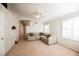 Bright living room with neutral colors, tile floors, large windows, and a comfortable sectional sofa at 204 Mchenry St, Las Vegas, NV 89144