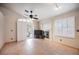Bright living room featuring tile floors, a ceiling fan, fireplace, and sliding door access to the outdoor patio space at 204 Mchenry St, Las Vegas, NV 89144