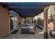Relaxing covered patio featuring comfortable wicker furniture and desert landscaping at 204 Mchenry St, Las Vegas, NV 89144