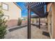 Inviting outdoor patio with a pergola, stylish pavers, and comfortable seating for relaxation and entertainment at 204 Mchenry St, Las Vegas, NV 89144