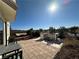 Backyard patio featuring stone pavers, built-in grill, outdoor seating, and lush landscaping at 2503 Kaymin Ridge Rd, Henderson, NV 89052