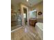 Neutral bathroom featuring glass shower, soaking tub, and wood cabinets at 2503 Kaymin Ridge Rd, Henderson, NV 89052