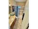 Well-lit bathroom featuring a shower-tub combo, neutral tile, and a vanity with sink at 2503 Kaymin Ridge Rd, Henderson, NV 89052