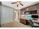 Bright bedroom with built-in desk, cabinets, and a ceiling fan offers a functional and stylish workspace at 2503 Kaymin Ridge Rd, Henderson, NV 89052