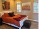 Comfortable bedroom featuring an orange comforter with warm brown decor at 2503 Kaymin Ridge Rd, Henderson, NV 89052