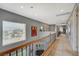 Bright hallway with wood railing overlooks the landscape view at 2503 Kaymin Ridge Rd, Henderson, NV 89052