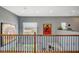 Upstairs loft with wrought iron banister, large windows and unique wall art at 2503 Kaymin Ridge Rd, Henderson, NV 89052
