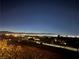 An enchanting night view of the city lights against the dark silhouette of distant mountains at 2503 Kaymin Ridge Rd, Henderson, NV 89052