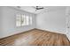 Bright bedroom with plantation shutters, ceiling fan and wood-look flooring at 2535 Jada Dr, Henderson, NV 89044