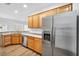 Well-lit kitchen boasting stainless steel appliances, light wood cabinets, ample counter space, and modern flooring at 2535 Jada Dr, Henderson, NV 89044