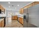 Bright, open kitchen featuring stainless steel appliances, light wood cabinets, and hardwood flooring, perfect for cooking at 2535 Jada Dr, Henderson, NV 89044