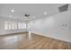 Spacious living room features wood-look floors, neutral white walls, natural lighting, and plantation shutters on the windows at 2535 Jada Dr, Henderson, NV 89044
