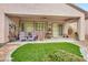 Covered patio with seating, ceiling fan and landscaping at 2535 Jada Dr, Henderson, NV 89044