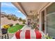 Inviting covered patio with ceiling fan and serene backyard view with manicured landscaping at 2535 Jada Dr, Henderson, NV 89044