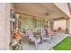 Relaxing covered patio featuring a ceiling fan, seating and access to the backyard at 2535 Jada Dr, Henderson, NV 89044