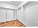 Bright, walk-in closet with built-in shelves and wood-look flooring at 2535 Jada Dr, Henderson, NV 89044