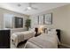 Well-lit bedroom with two twin beds, soft bedding, and modern decor at 2672 Mystere Ct, Las Vegas, NV 89117