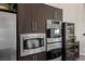 Modern kitchen features stainless steel appliances and sleek, dark wood cabinetry, perfect for culinary enthusiasts at 2672 Mystere Ct, Las Vegas, NV 89117