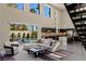 Inviting living room featuring high ceilings, backyard pool access, and modern staircase at 2672 Mystere Ct, Las Vegas, NV 89117