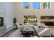 Spacious living room featuring modern design elements and abundant natural light from large windows at 2672 Mystere Ct, Las Vegas, NV 89117