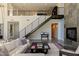 Open-concept living area with modern staircase, fireplace, and large windows for natural light at 2672 Mystere Ct, Las Vegas, NV 89117