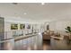 Upstairs living room features dark hardwood floors, plenty of light, and comfortable seating area at 2672 Mystere Ct, Las Vegas, NV 89117