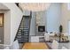 The open-concept living area features a fireplace, modern staircase, and great lighting at 2672 Mystere Ct, Las Vegas, NV 89117