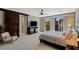Spacious main bedroom with sliding glass doors to a balcony and a sliding barn door at 2672 Mystere Ct, Las Vegas, NV 89117