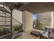 Outdoor living space with a spiral staircase and comfortable seating area with pillows at 2672 Mystere Ct, Las Vegas, NV 89117