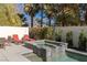 Inviting backyard oasis with pool, spa, lounge chairs, and lush landscaping at 2672 Mystere Ct, Las Vegas, NV 89117