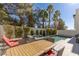 Outdoor patio with a pool, spa, dining table, lounge chairs, and lush landscaping at 2672 Mystere Ct, Las Vegas, NV 89117