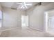 Neutral-toned bedroom with an ensuite bathroom and plush carpet, featuring high vaulted ceiling at 3351 Indian Shadow St # 204, Las Vegas, NV 89129