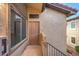 Close-up of apartment door with exterior light, window, and stucco siding at 3351 Indian Shadow St # 204, Las Vegas, NV 89129